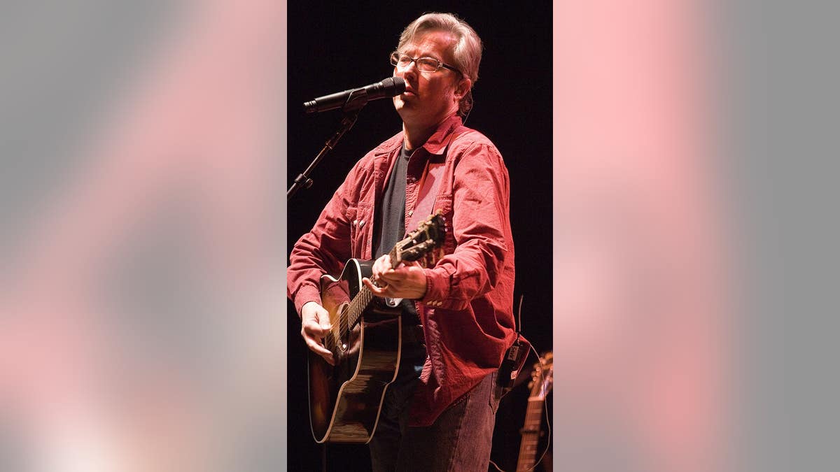 Radney Foster singing on stage during Sara Evans concert at Murat Theatre in Indianapolis