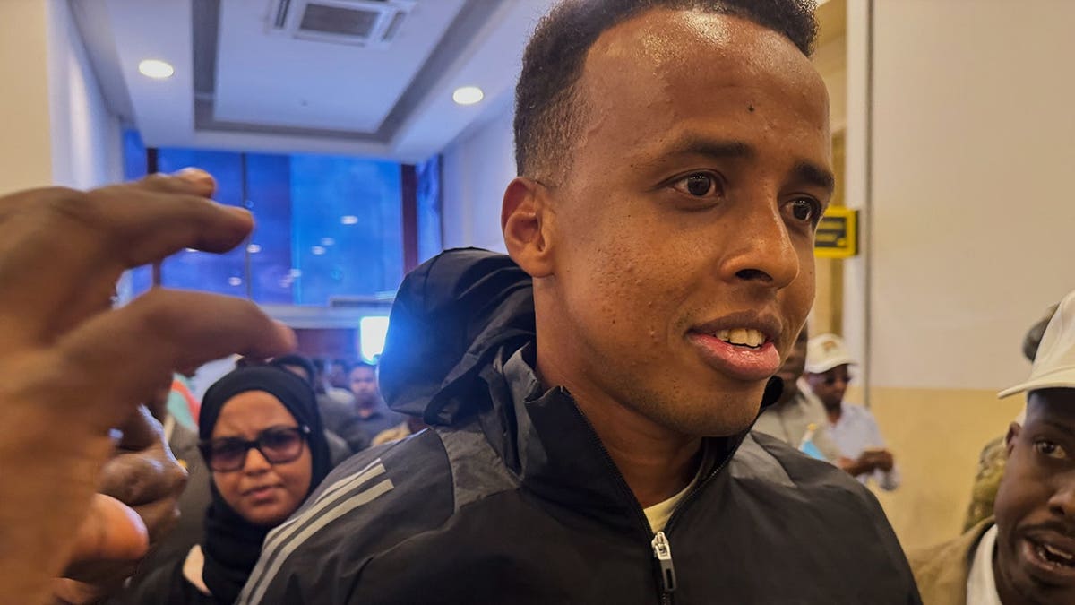 Referee Omar Artan arriving astatine an airdrome successful Mogadishu, Somalia.