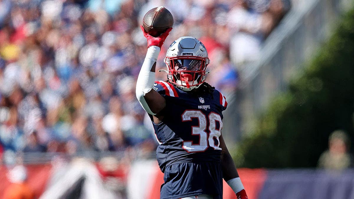 Rhamondre Stevenson reacting on field during NFL game at Gillette Stadium