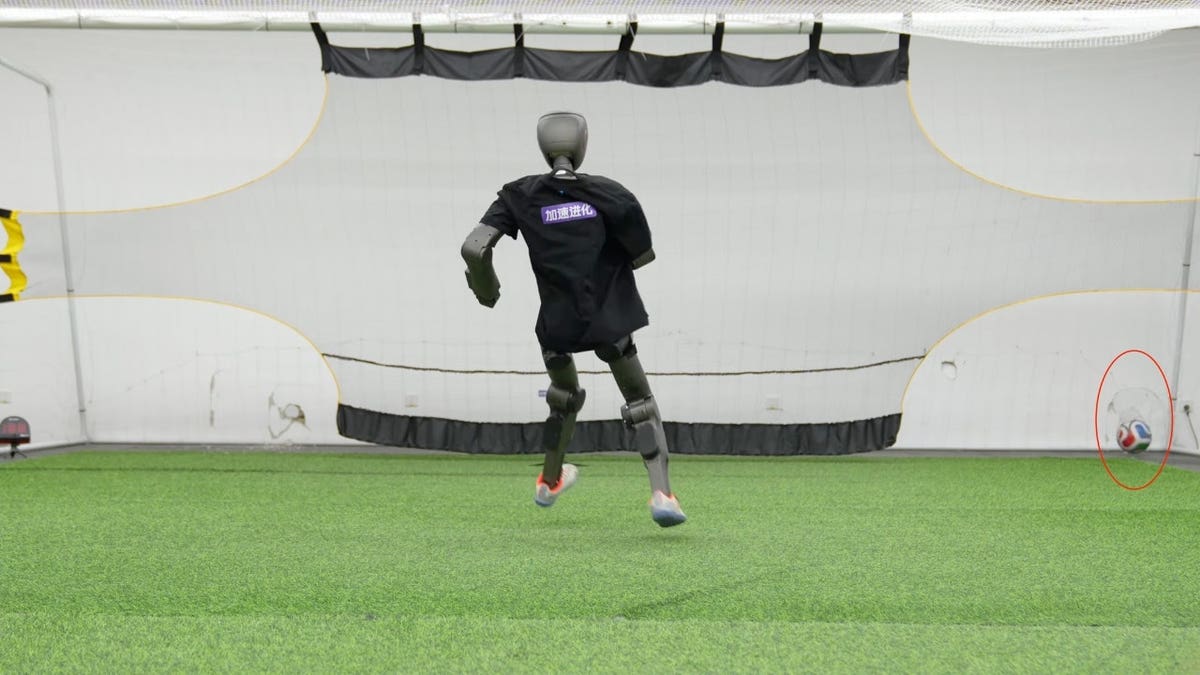 A robot kicking a soccer ball