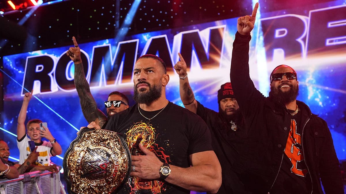 Roman Reigns, Jey Uso, Jacob Fatu and Jimmy Uso walking to the ring at CFG Bank Arena.
