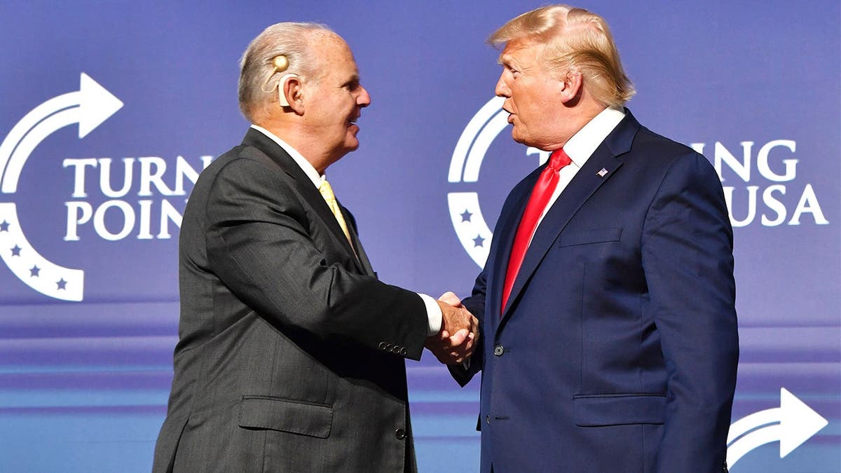 Rush Limbaugh shakes hands with President Donald Trump at Turning Point USA event.