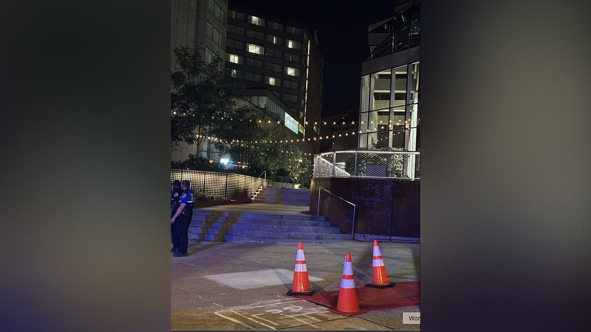 image shows traffic cones, officers on crime scene