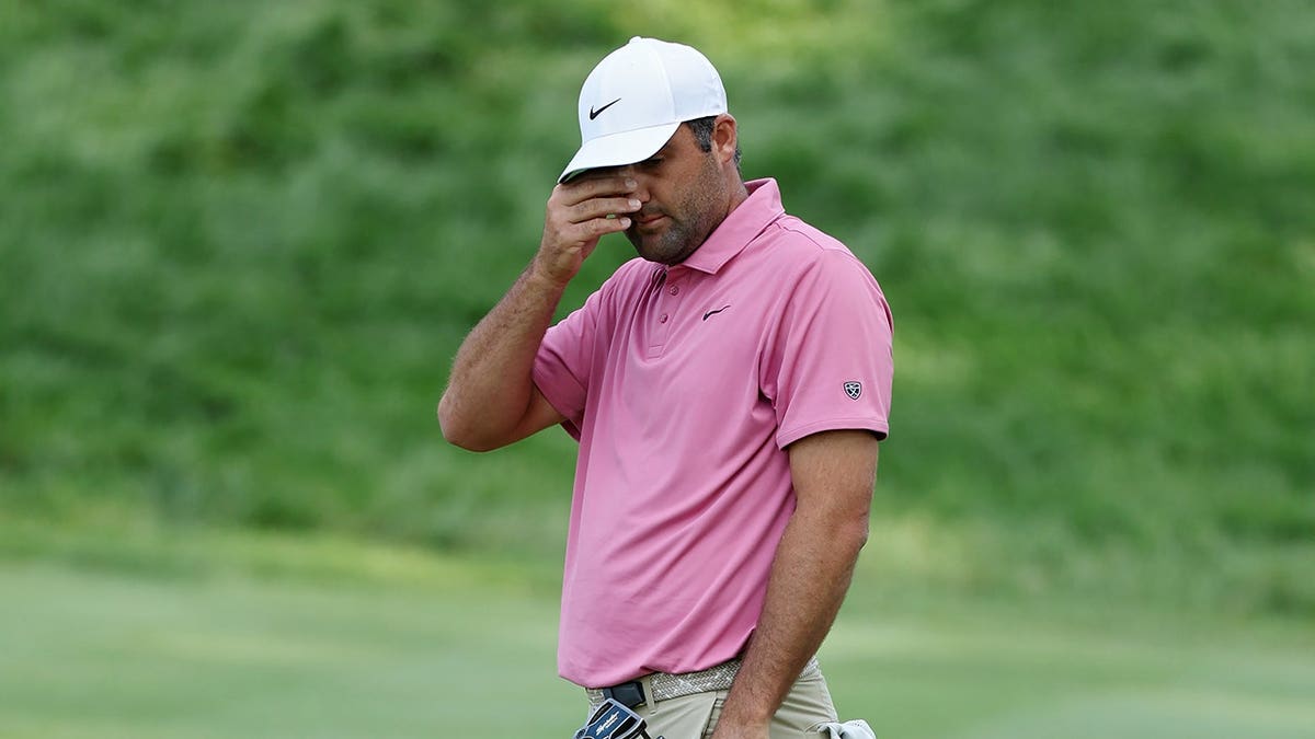 Scottie Scheffler reacting after missing a putt on the 18th green at TPC River Highlands