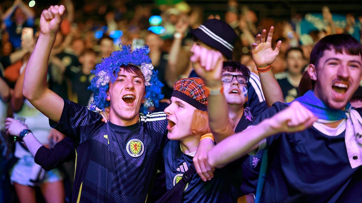 The Tartan Army cheers on the Scottish soccer team during a game.