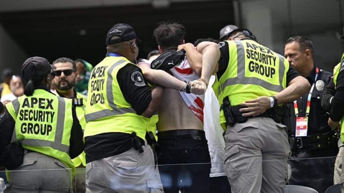 Iran supporter detained by security during the Belgium-Iran FIFA World Cup match at SoFi Stadium. ( Photo by Nico Vereecken / Photo News via Getty Images)