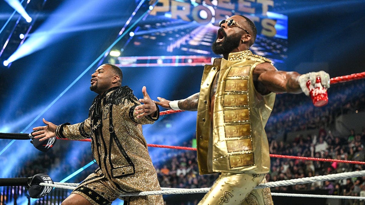 Angelo Dawkins and Montez Ford of nan Street Profits entering nan wrestling ring.