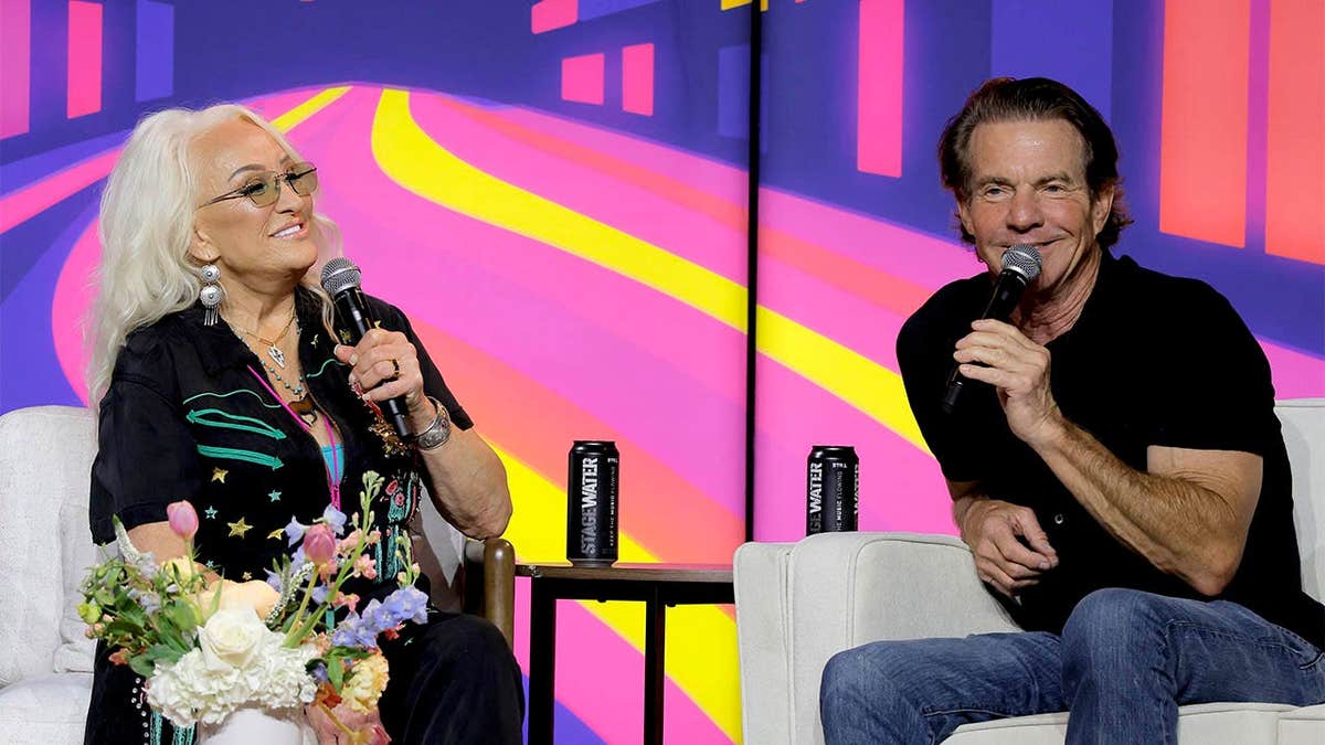 Tanya Tucker and Dennis Quaid speaking onstage at CMA Close Up Stage in Nashville, Tennessee.