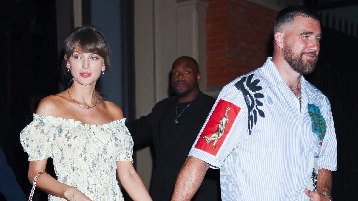 Taylor Swift and Travis Kelce standing together outside Zero Bond in New York City
