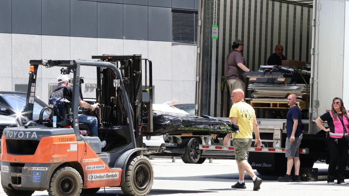 Taylor Swift wedding preparations with equipment and grass being loaded at Madison Square Garden