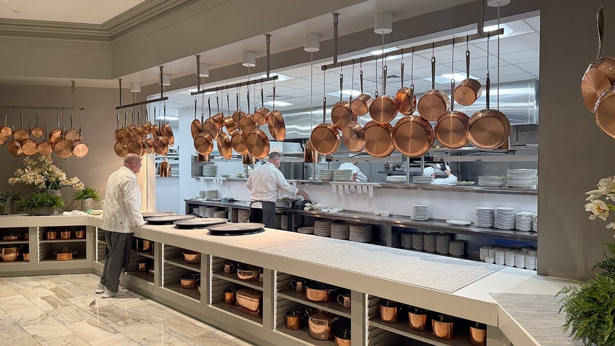 The Bedford restaurant kitchen is shown with dozens of copper pans.
