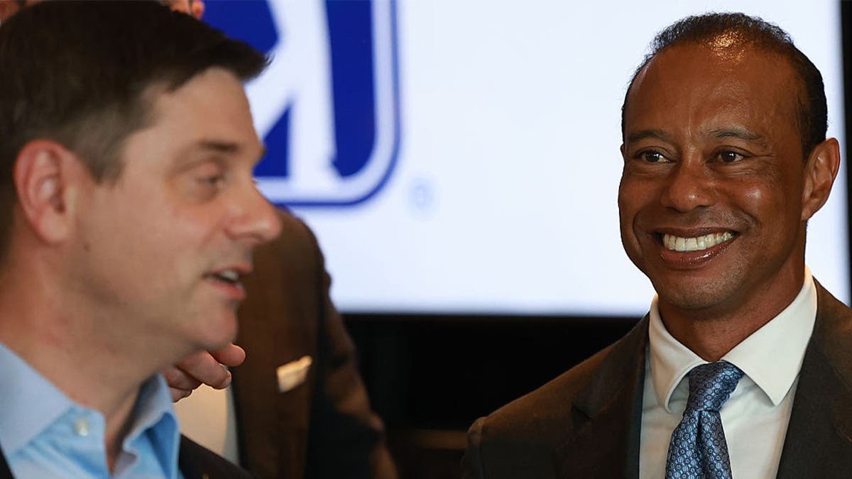 Tiger Woods of the United States looks towards Brian Rolapp