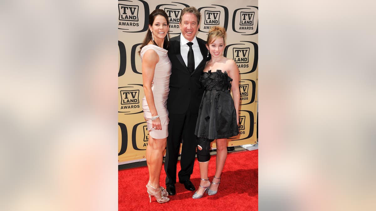 Actor Tim Allen standing with actress Jane Hajduk and daughter Katherine Allen at an event.