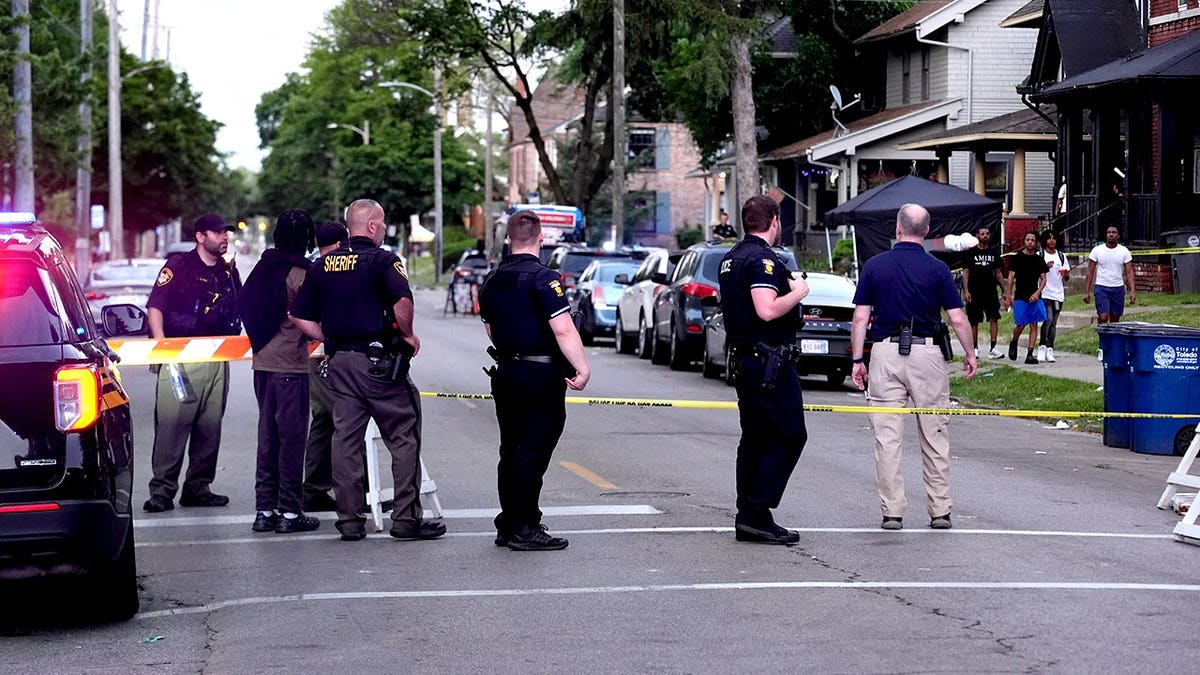 Police officers standing near a shooting scene at a community festival in Toledo, Ohio