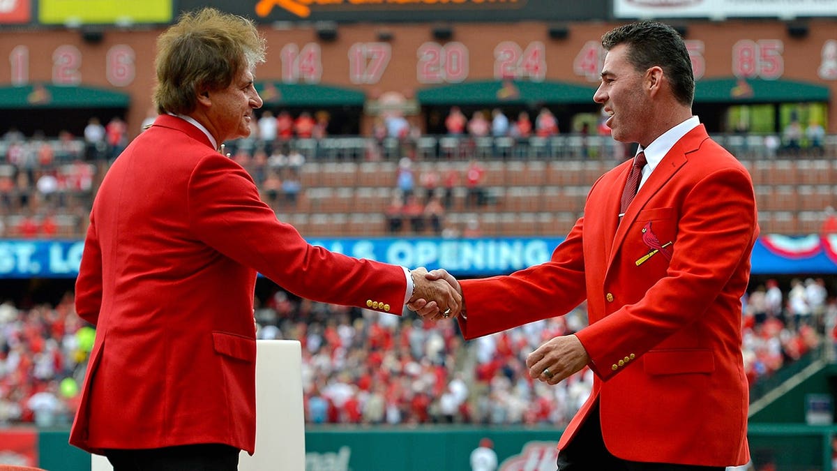 Tony Larussa shaking hands with Jim Edmonds at Busch Stadium.