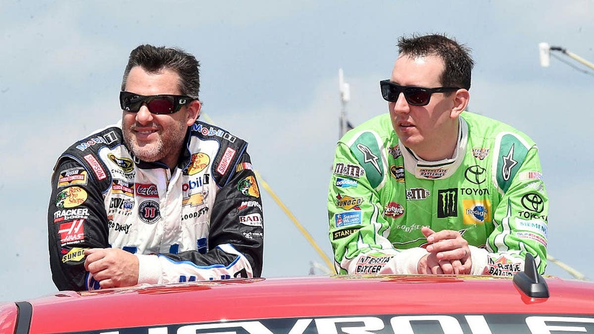 Tony Stewart and Kyle Busch standing together at Michigan International Speedway.
