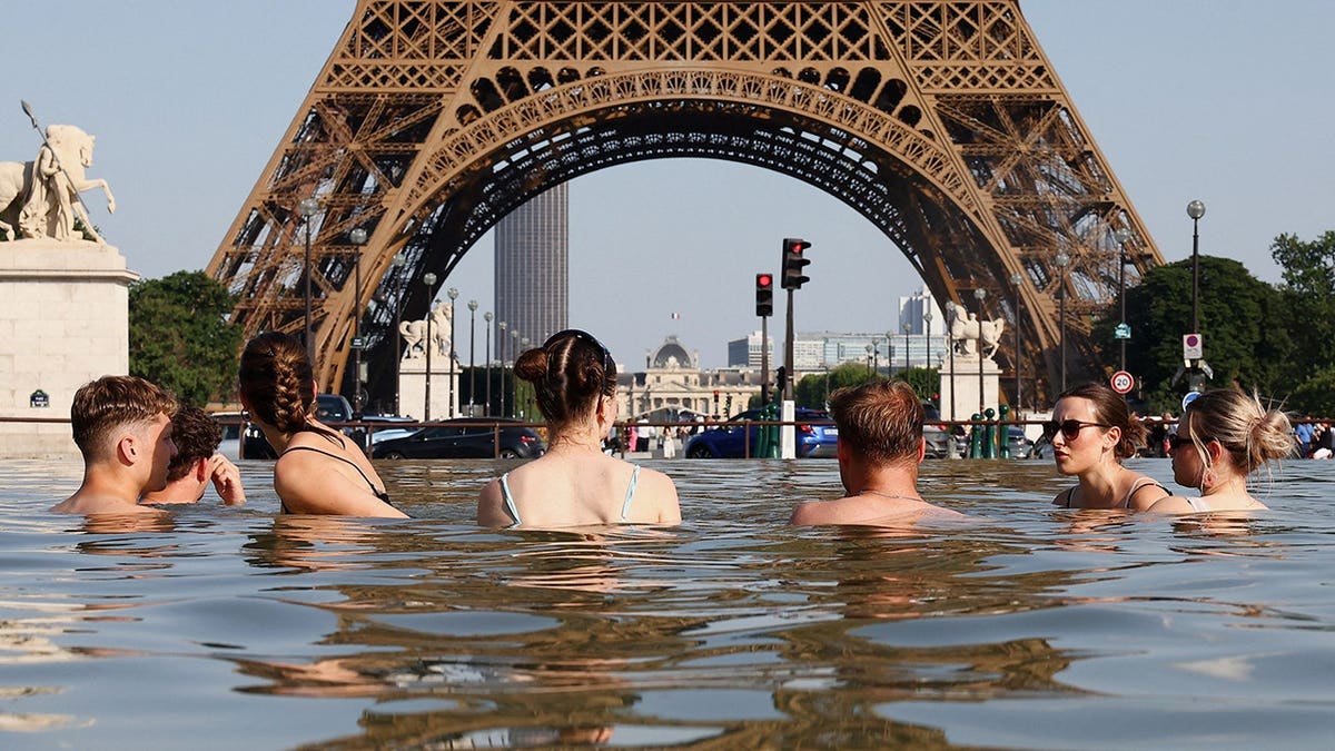 People cooling disconnected  successful  the Trocadero Fountain adjacent   the Eiffel Tower successful  Paris