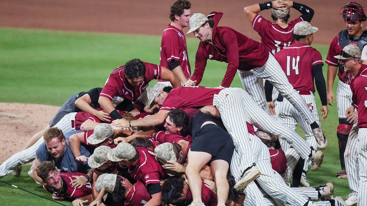 Troy baseball players celebrating on the field at Condron Family Ballpark