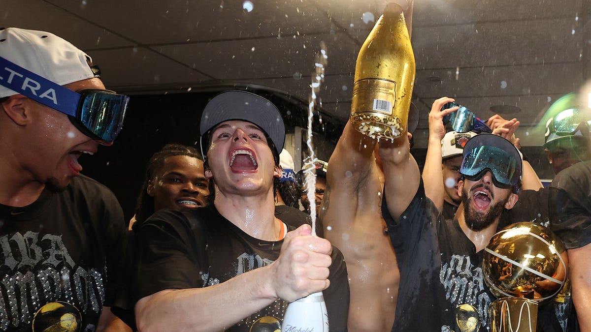 Tyler Kolek and Landry Shamet celebrating with Larry O'Brien Championship Trophy at Frost Bank Center