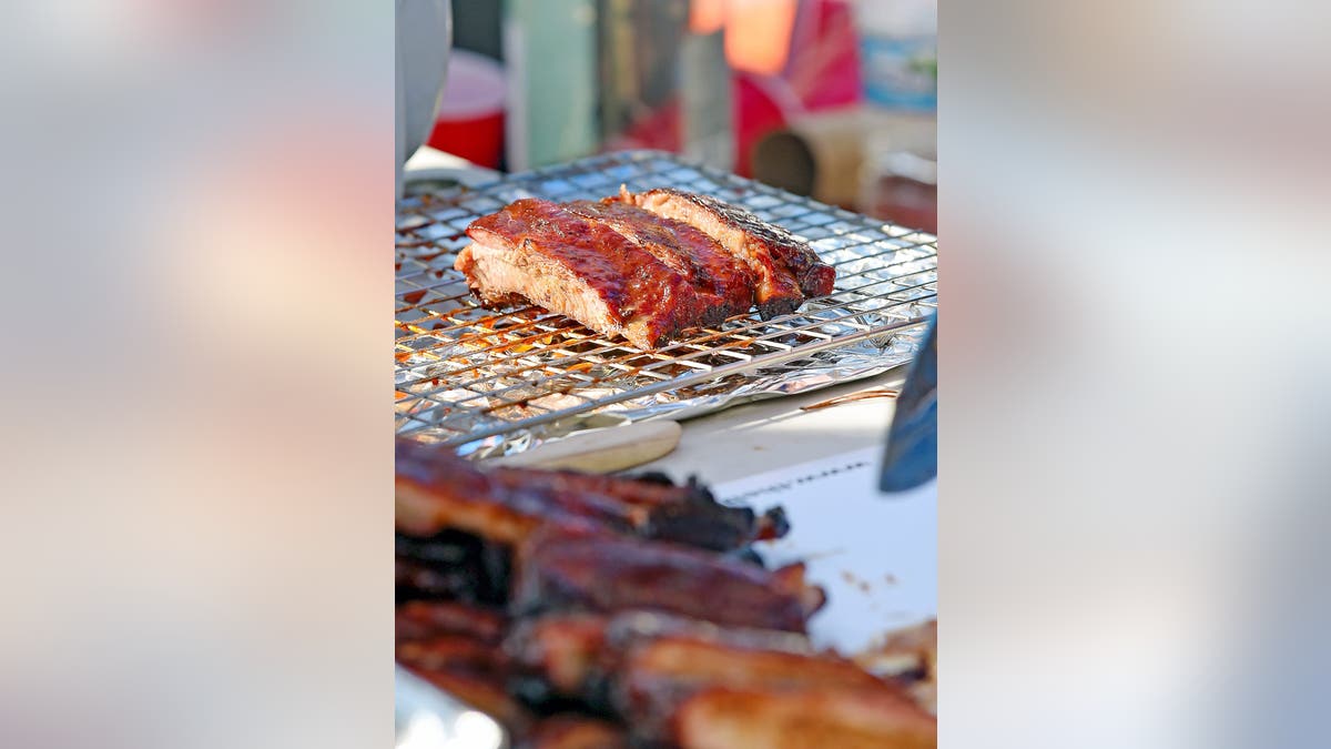 Ribs rest on a dip rack while John Witt prepares to submit ribs on Nov. 13, 2022, during the Kansas City Barbeque Society World Invitational Championship at Noccalula Falls Park in Gadsden. Witt is part of the Shmack Q BBQ team from Chicago. Kcbs World Invitational Championship