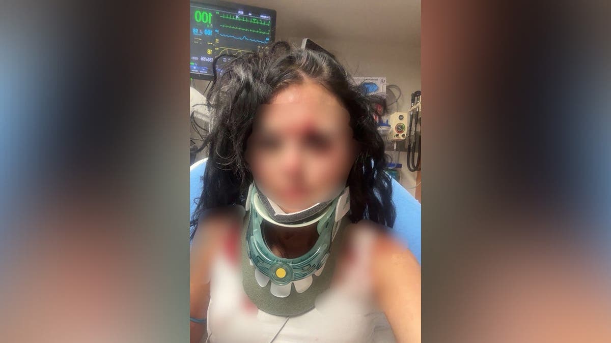 photo shows blurred image of victim in hospital with neck brace