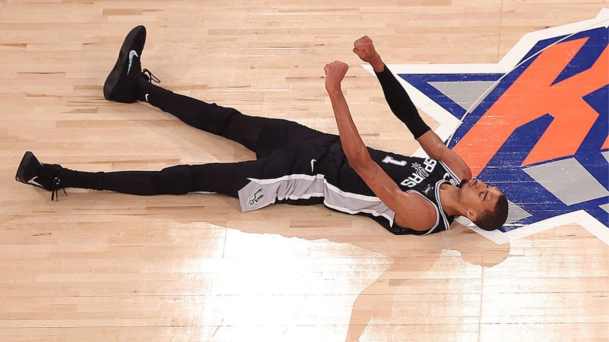 Victor Wembanyama #1 of the San Antonio Spurs reacts after shooting a three point basket