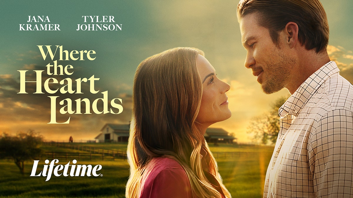 Jana Kramer and co-star facing each other in profile against a countryside sunset background.