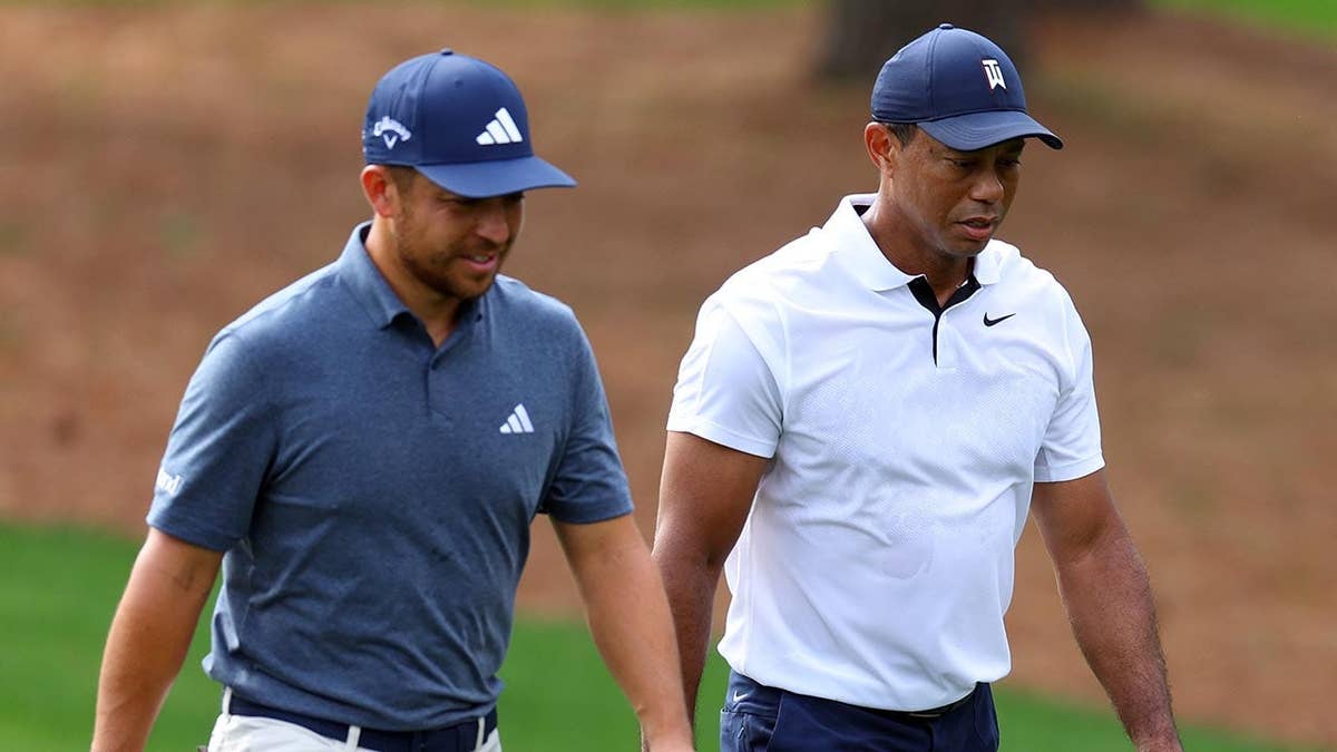Xander Schauffele and Tiger Woods stepping up nan 3rd fairway astatine Augusta National Golf Club.