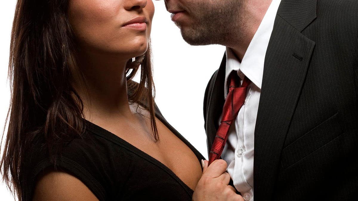 Young couple embracing closely in a vertical photo