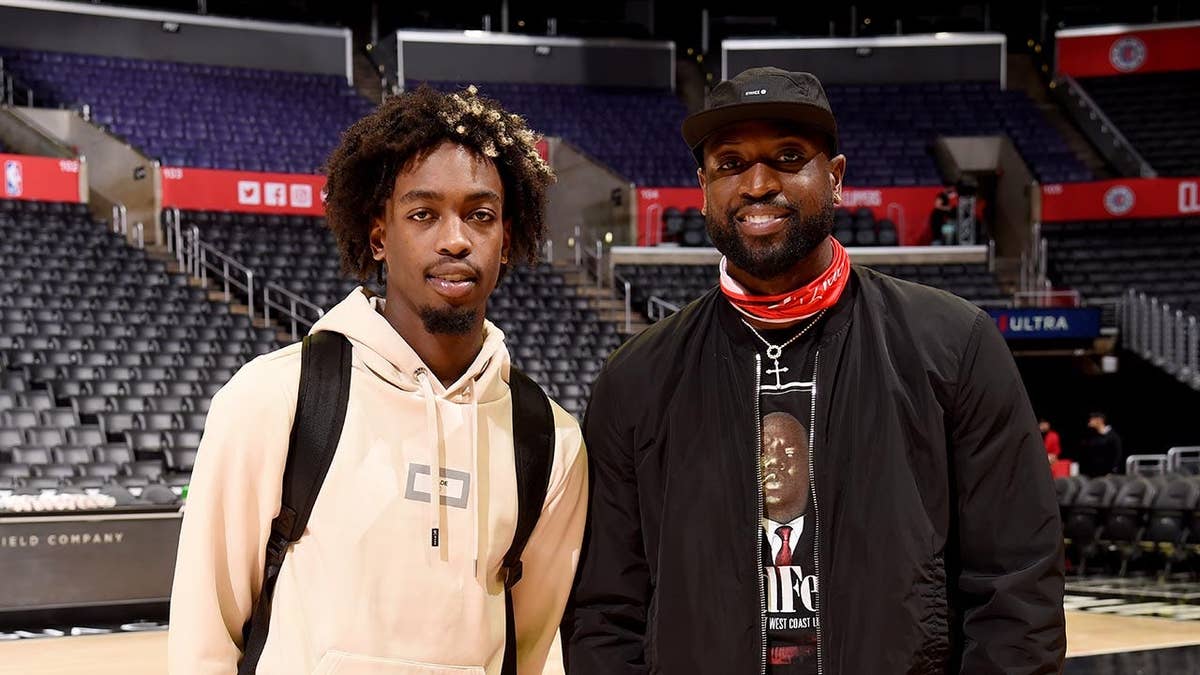 Zaire Wade posing with his father Dwyane Wade at Staples Center in Los Angeles