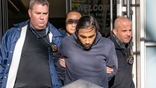 Hiram Carrero escorted by police on December 4, 2025.