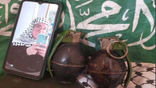 Catherine Beth Washburn pictured with two hand grenades in front of Hamas flag.