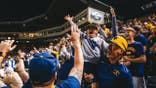 West Virginia fans celebrate the Mountaineers defeating Kentucky for a spot in the NCAA Tournament Super Regional
