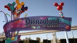 Pedestrians walking near the entrance to Disneyland Resort in Anaheim, California