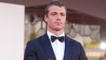 Gabriel Basso standing on the red carpet at the Venice International Film Festival.