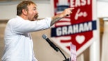 graham platner exults and points during a primary victory speech