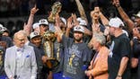 New York Knicks guard Jalen Brunson celebrating with teammates on basketball court.