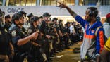 NYPD officers push New York Knicks fans back