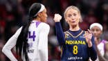 Indiana Fever guard Sophie Cunningham pointing at Phoenix Mercury forward-guard DeWanna Bonner during a basketball game.