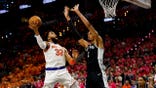 New York Knicks C Karl-Anthony Towns attacks the basket against San Antonio Spurs big Victor Wembanyama during Game 1 of the 2026 NBA Finals at Frost Bank Center in Texas.