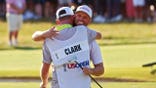 Wyndham Clark celebrating with caddie David Pelekoudas at Shinnecock Hills Golf Club