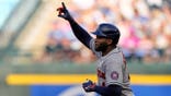 Houston Astros' Yordan Alvarez celebrating after hitting a home run during a baseball game.