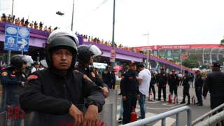 Anti-government protesters clash with riot police outside World Cup opener while Shakira performs inside
