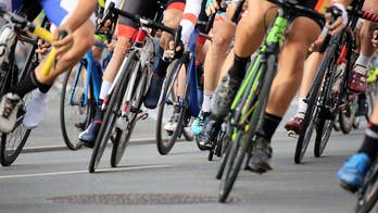 Elderly fan on a mobility scooter sends cyclists flying through the air after driving onto course mid-race