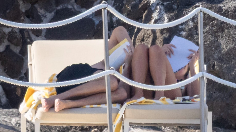 Dua Lipa and Callum Turner lounging together in Italy.
