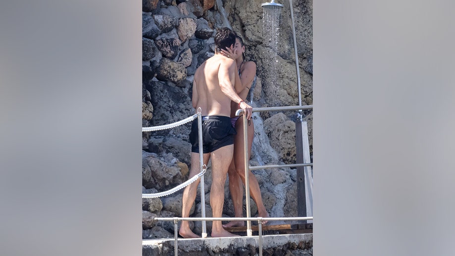 Dua Lipa and Callum Turner kissing under the shower in Italy in June 2026.