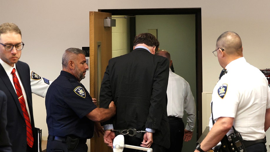 Rex Heuermann escorted out a courtroom at Suffolk County Court.