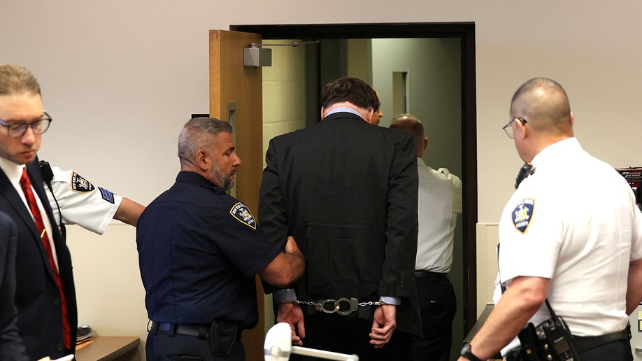 Rex Heuermann escorted out a courtroom at Suffolk County Court.