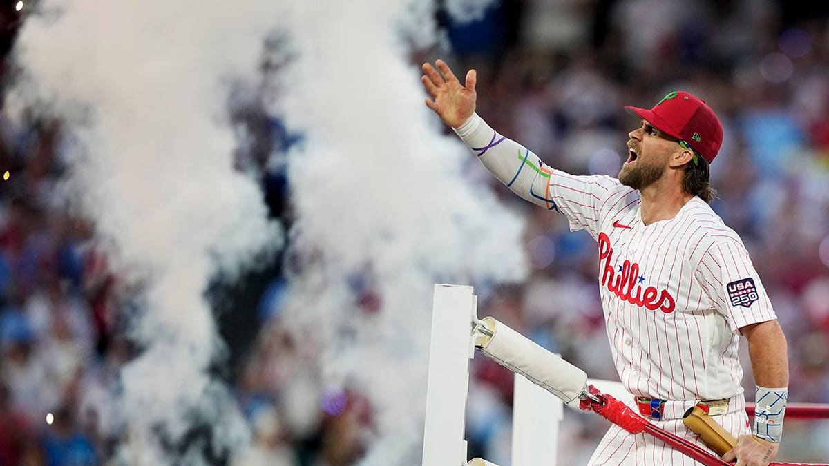 Bryce Harper stands on the field in Philadelphia.