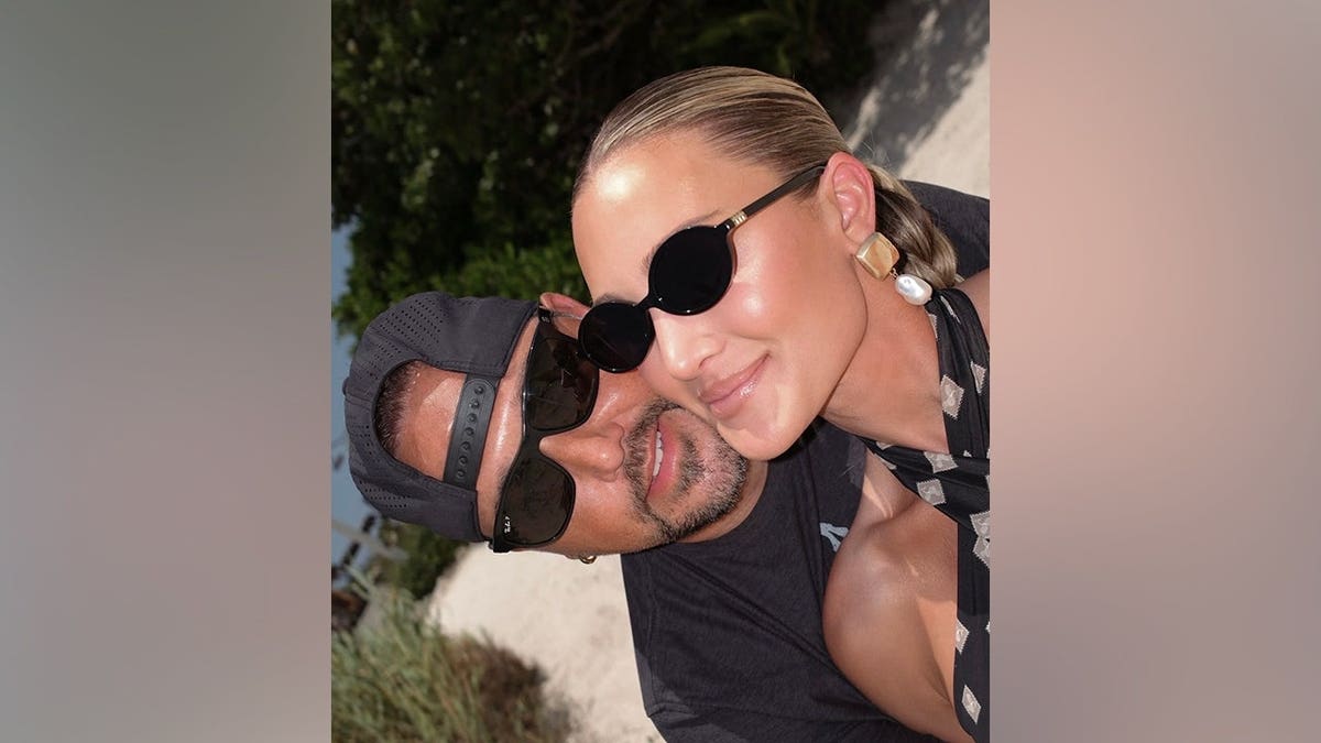 Brittany Aldean smiles beside husband Jason Aldean while taking a selfie during the family's Bahamas vacation.